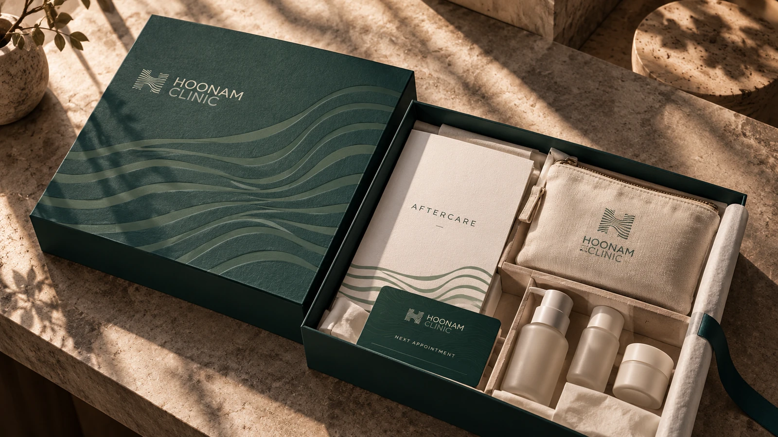 Open green Hoonam aftercare kit with organised booklet, pouch and personal-care containers