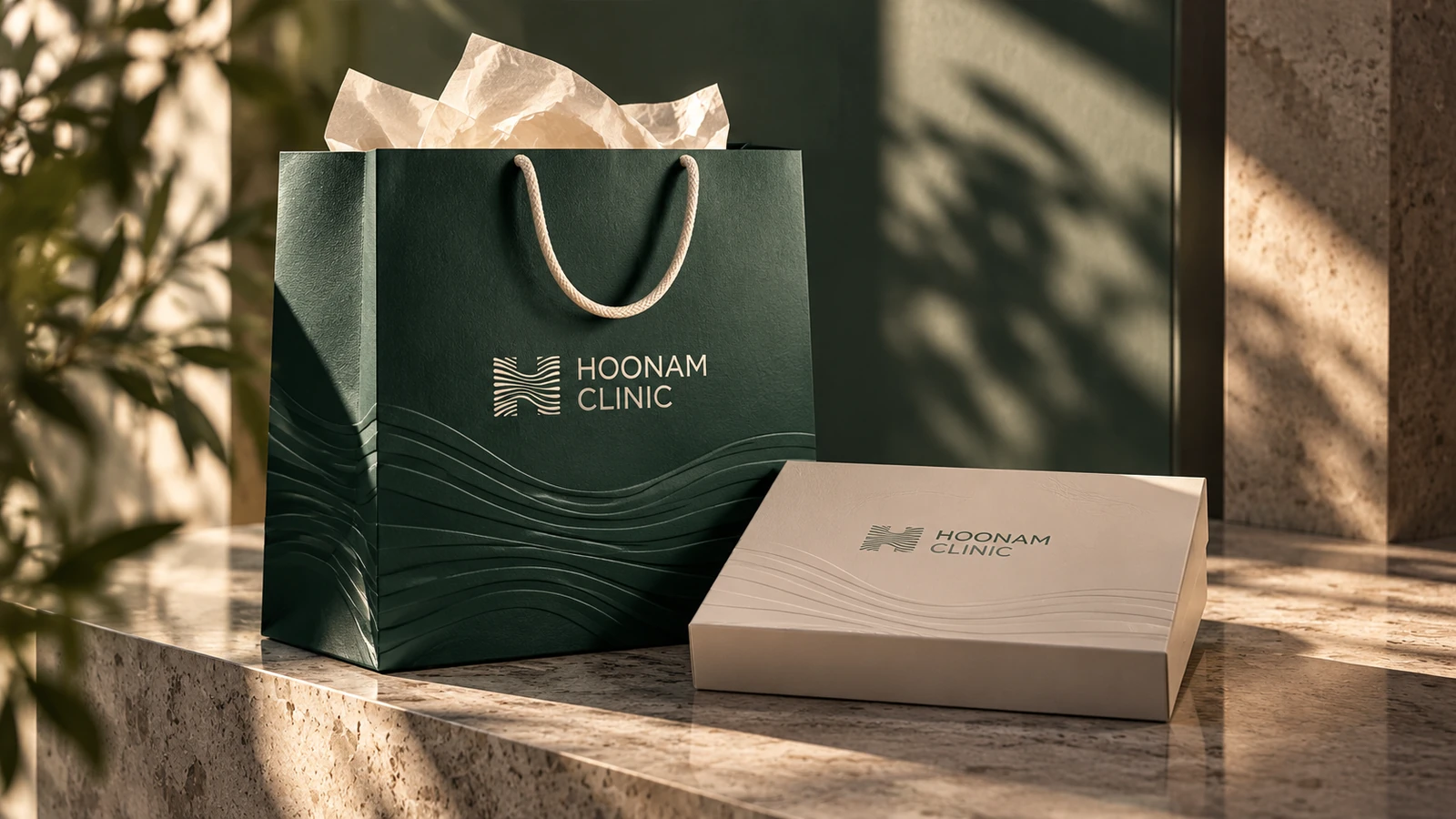Hoonam paper shopping bag and cream aftercare box in directional sunlight