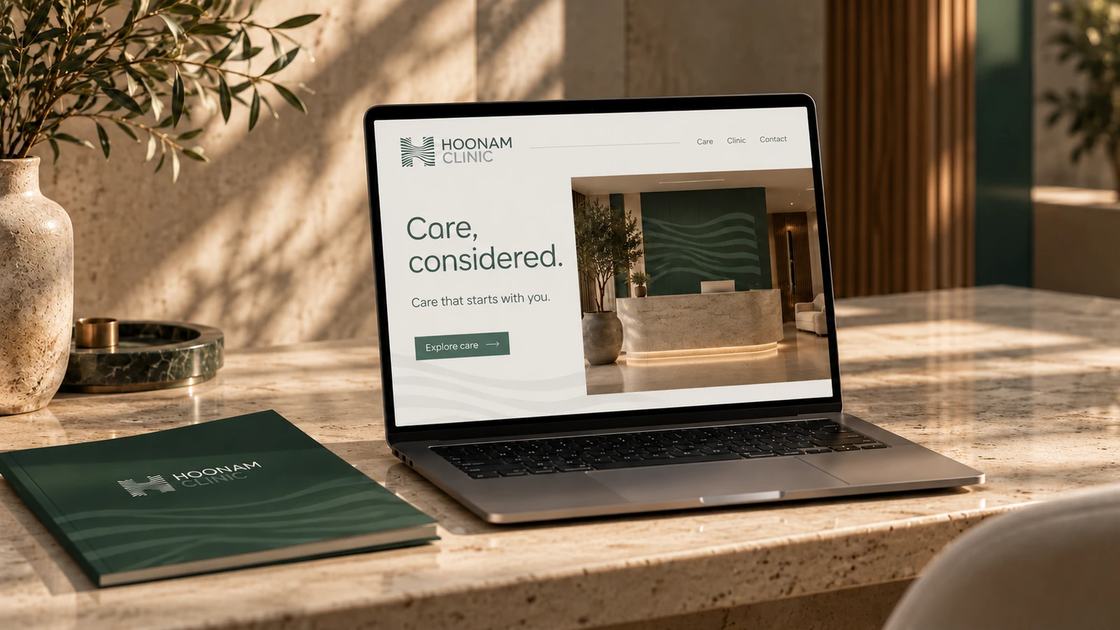 Illustrative Hoonam website concept on a laptop in a sunlit stone interior